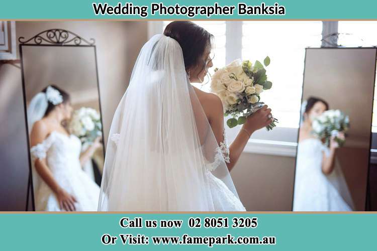 Photo of the Bride holding flower at the front of the mirrors Banksia NSW 2216