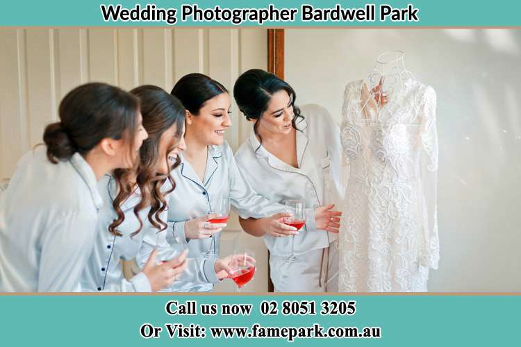 Photo of the Bride and the bridesmaids checking the wedding gown Bardwell Park NSW 2207