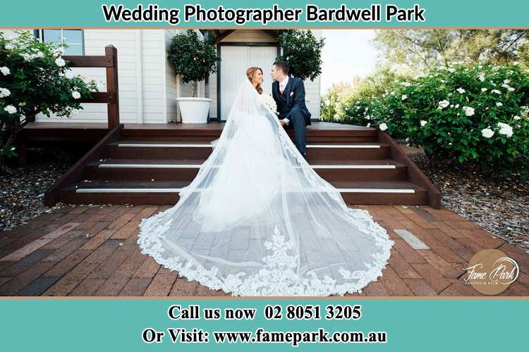 Photo of the Bride and the Groom looking each other while sitting at the staircase Bardwell Park NSW 2207