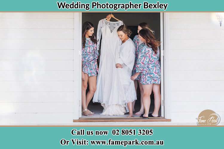 Photo of the Bride and the bridesmaids checking the wedding gown at the door Bexley NSW 2207