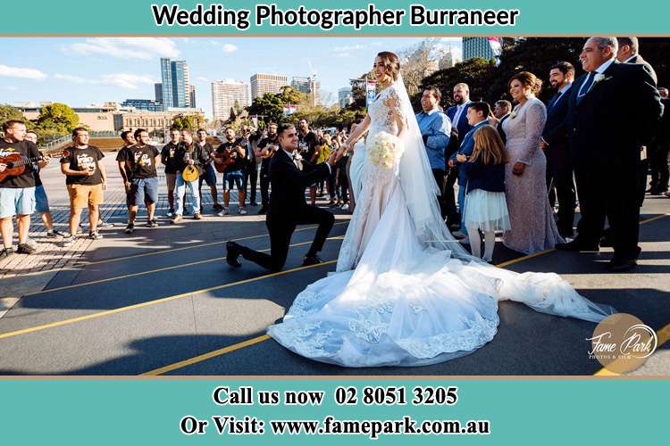 Groom Kneeling down in front of the Bride Burraneer NSW 2230