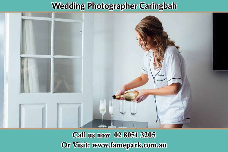 Photo of the Bride pouring wine on the glasses Caringbah NSW 2229