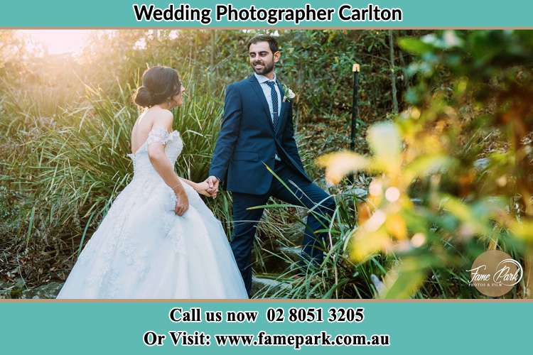 Photo of the Bride and the Groom going up the hill Carlton NSW 2218