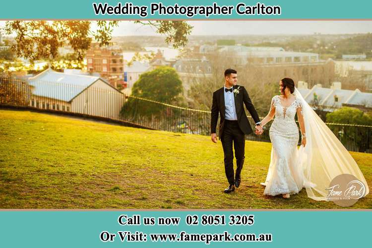 Photo of the Groom and the Bride holding hands at the yard Carlton NSW 2218