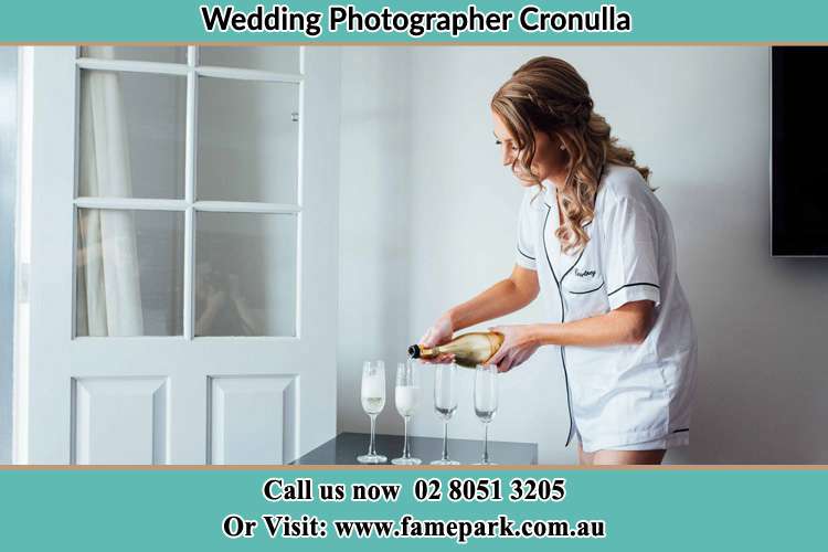 Photo of the Bride pouring wine on the glasses Cronulla NSW 2230