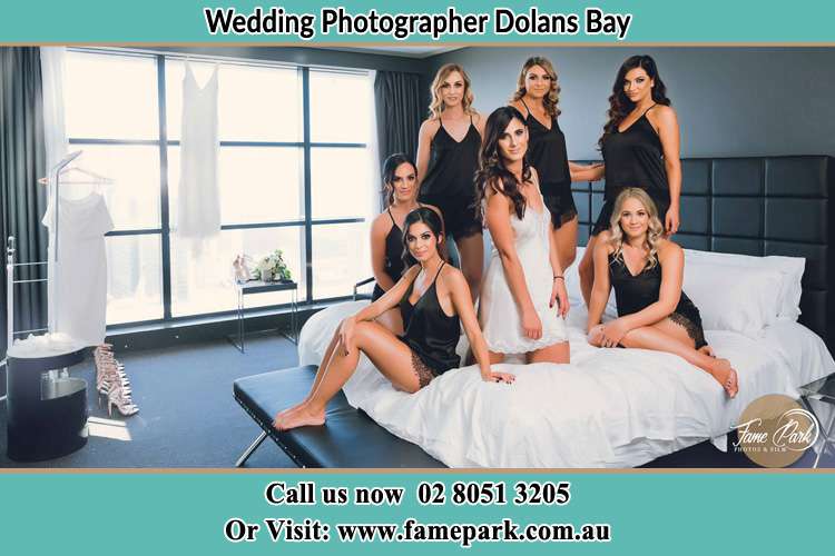 Photo of the Bride and the bridesmaids wearing lingerie on bed Dolans Bay NSW 2229