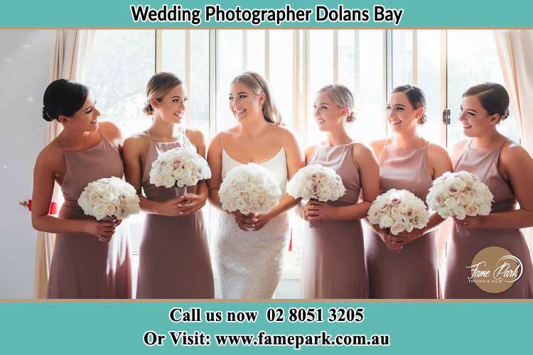 Photo of the Bride and the bridesmaids holding flower bouquet Dolans Bay NSW 2229