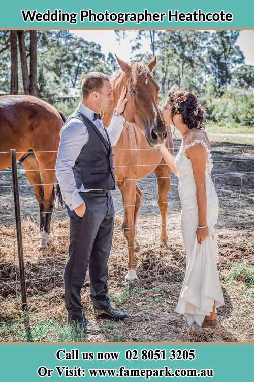 Photo of the Groom and the Bride caressing a horse Heathcote NSW 2233