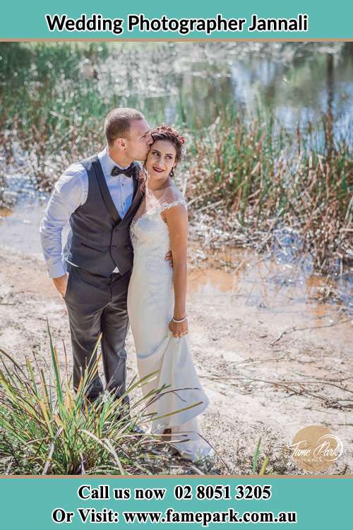 Photo of the Groom kiss the Bride near the lake Jannali NSW 2226