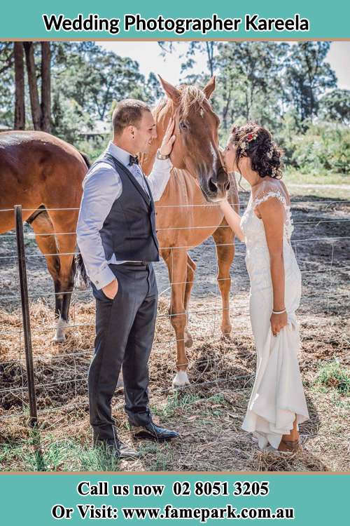 Photo of the Groom and the Bride caressing a horse Kareela NSW 2232