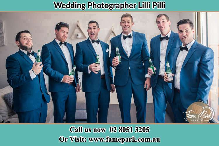 The groom and his groomsmen striking a wacky pose in front of the camera Lilli Pilli NSW 2229