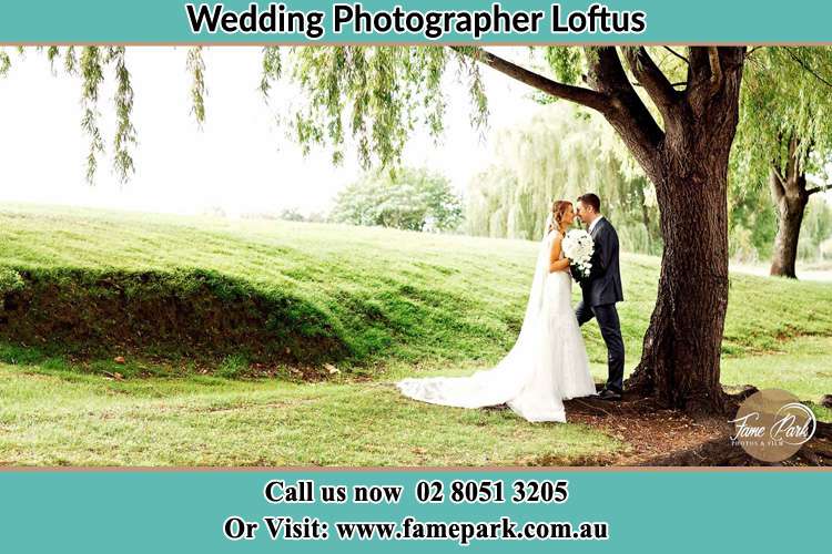 Photo of the Bride and the Groom kissing under the tree Loftus NSW 2232