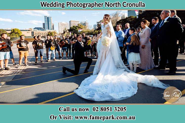 Groom Kneeling down in front of the Bride North Cronulla NSW 2230