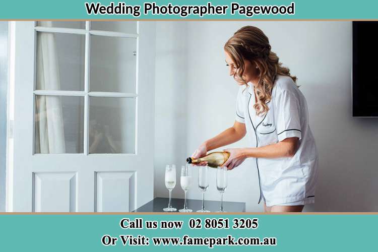 Photo of the Bride pouring wine on the glasses Pagewood NSW 2035