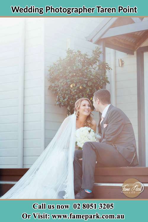 Photo of the Bride and the Groom looking each other while sitting at the staircase Taren Point NSW 2229