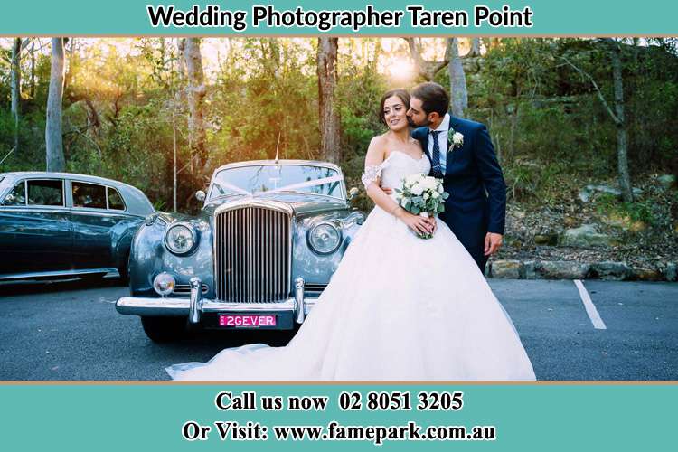 Photo of the Bride and the Groom at the fornt of the bridal car Taren Point NSW 2229