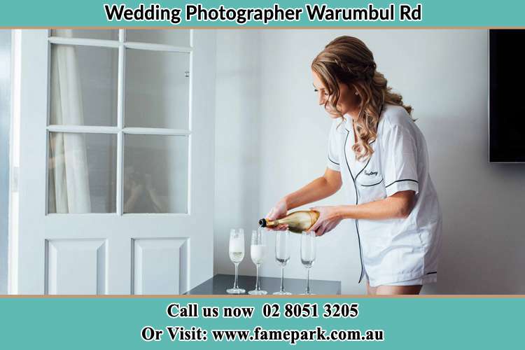 Photo of the Bride pouring wine on the glasses Warumbul Rd NSW 2233